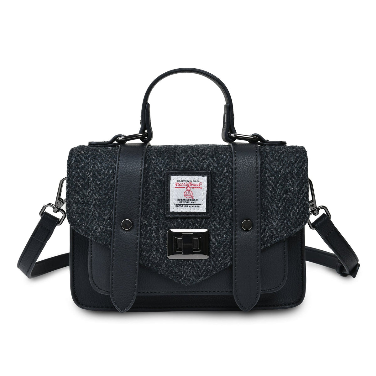 Black handbag with a tweed flap, top handle, and detachable shoulder strap. Features a metal clasp and logo patch.